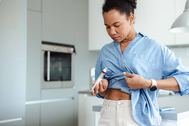 istock Woman administering medication in a brightly lit modern kitchen setting 2215002219