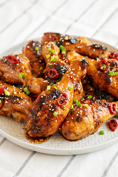 istock Homemade Easy Sticky Chicken Drumsticks on a Plate, side view. Close-up. 2215002530