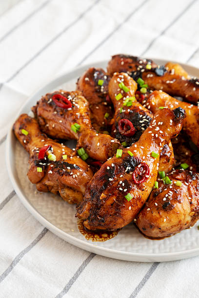 istock Homemade Easy Sticky Chicken Drumsticks on a Plate, side view. Close-up. 2215002577