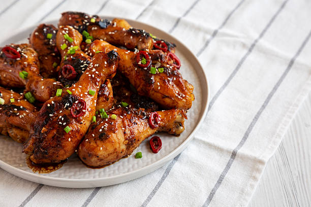 istock Homemade Easy Sticky Chicken Drumsticks on a Plate, side view. 2215002697