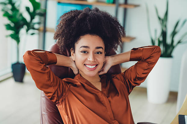 istock Young professional woman enjoying a break in a loft styled office workspace with modern design features and natural daylight setting 2215003314