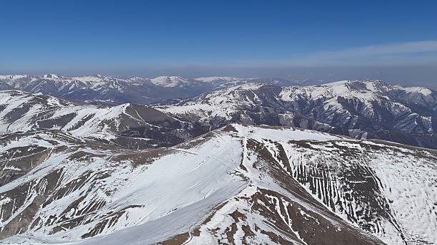 istock Snow covered mountain ranges under clear blue sky 2215003596