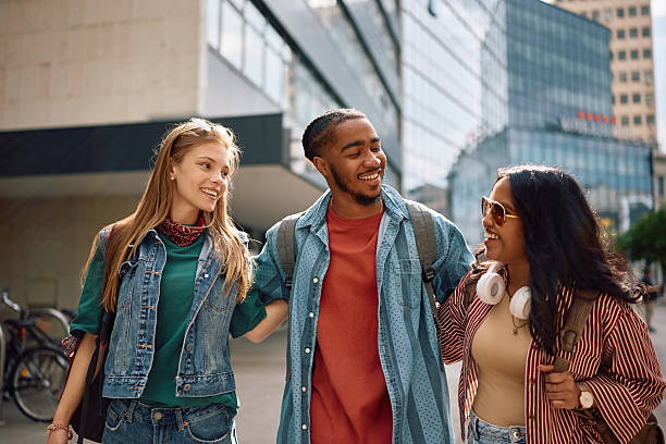 istock Multiracial group of students walking through campus. 2215003722