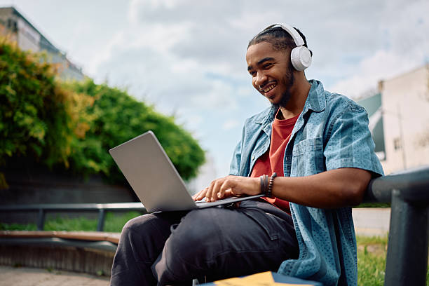 istock Happy black student surfing the net on laptop at university campus. 2215003750