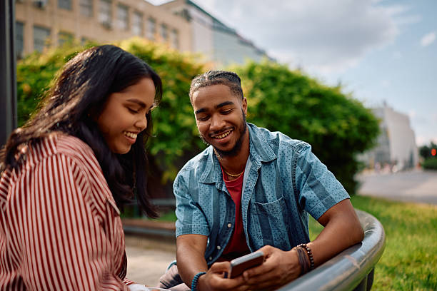 istock Multiracial university couple using smart phone at campus. 2215003758