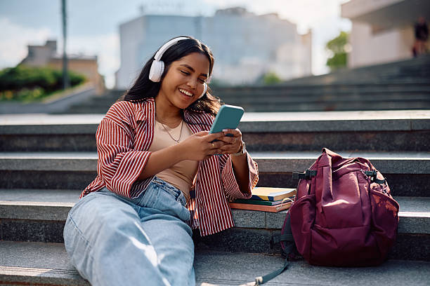 istock Happy Indian student using her smart phone at university campus. 2215003853