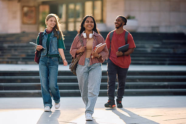 istock Multiracial group of happy students walking through university campus. 2215003886