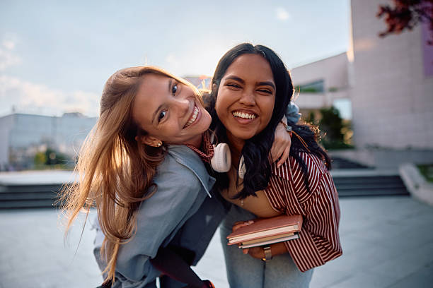 istock Cheerful female students having fun at university campus and looking at camera. 2215003914