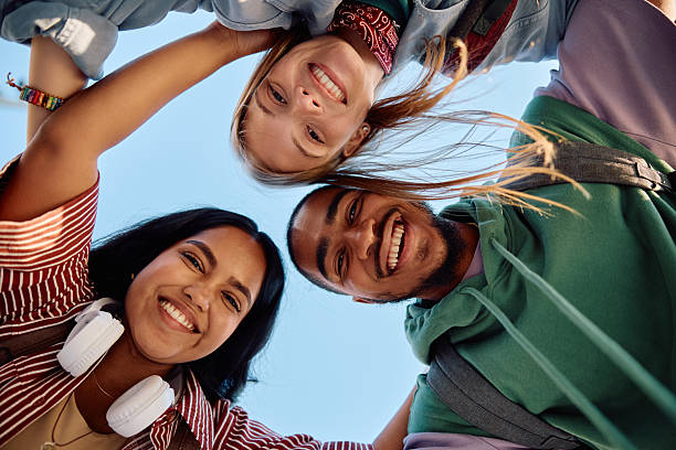 istock Below view of happy multiracial students looking at camera. 2215003928