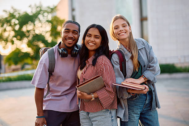 istock Group of happy students at university campus looking at camera. 2215003975
