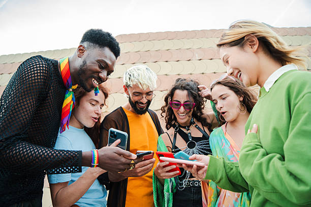 istock Group of diverse and multiracial young people having fun together using their smartphone on a meeting. Adult friends sharing photos and sending messages on the social media cell phone application 2215004334