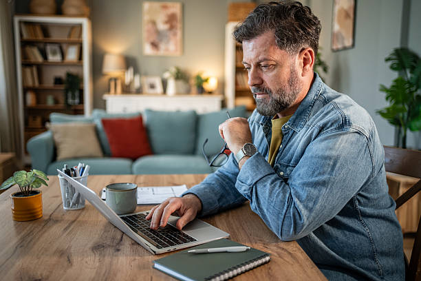 istock Focused mature professional working remotely from home office 2215004790