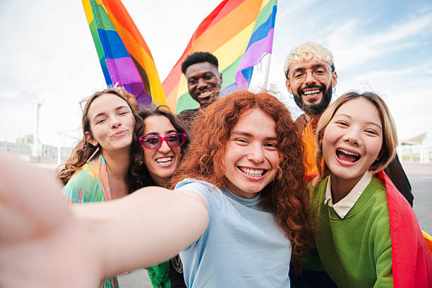 istock Joyful diverse friends celebrating together with rainbow flags during pride festivities while capturing a fun selfie to commemorate their happiness and support for the lgbt community in a delightful moment 2215005072