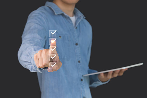 istock Checklist concept. Businessman is marking checkboxes. 2215005073