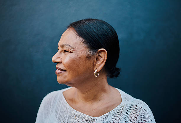 istock Thoughtful Mature Woman Against Blue Background 2215006693