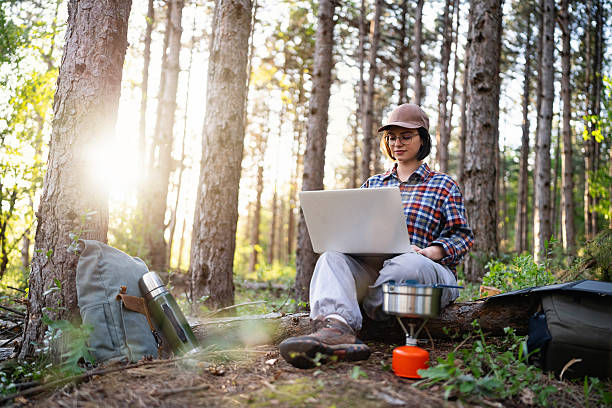 istock Person Working on Laptop in Forest, Enjoying Remote Outdoor Work 2215007042