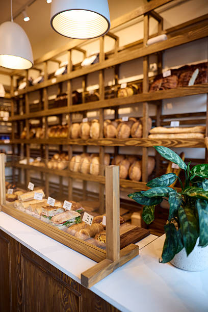 istock Tempting sandwiches and various breads displayed on wooden shelves in a bakery 2215007456