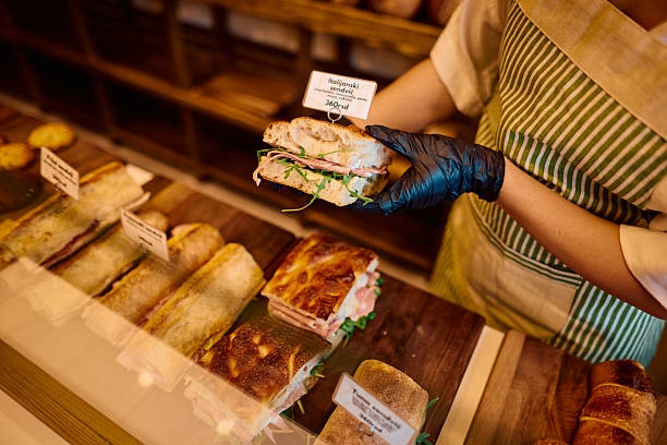 istock Baker showing a delicious sandwich in a bakery shop 2215007831