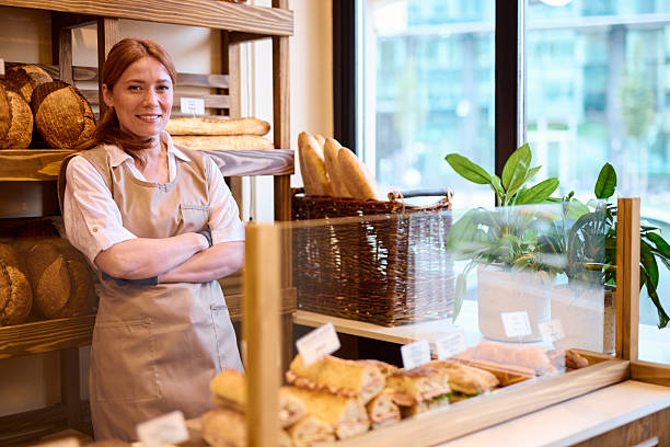 istock Confident baker posing with arms crossed in her bakery shop 2215008189