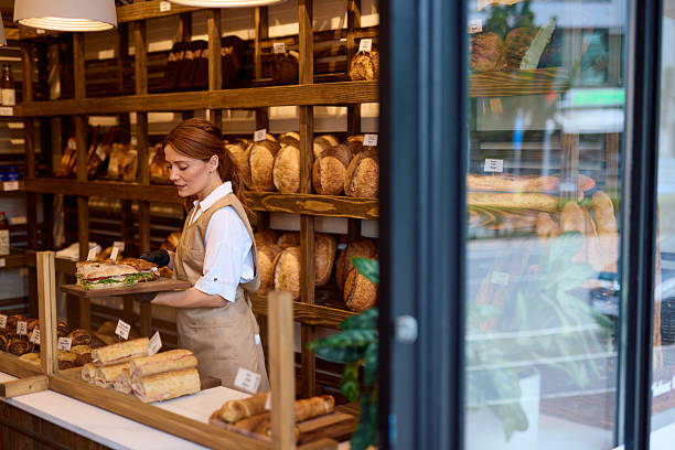 istock Saleswoman serving a sandwich in a bakery 2215008871