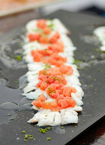istock Swordfish carpaccio with grapefruit and dill on black slate plate 2215009788