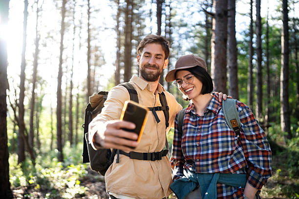 istock Young couple taking a selfie during a hike in a peaceful forest 2215009987