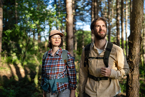 istock Young couple exploring a forest during a sunny day hike 2215012805
