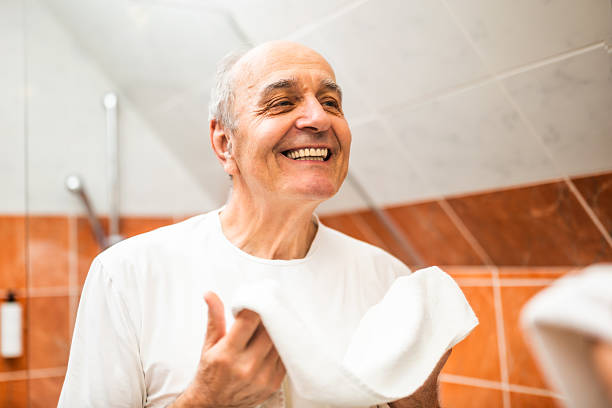 istock Confident elderly man looking at his reflection in bathroom mirror and  checking his smile 2215016922