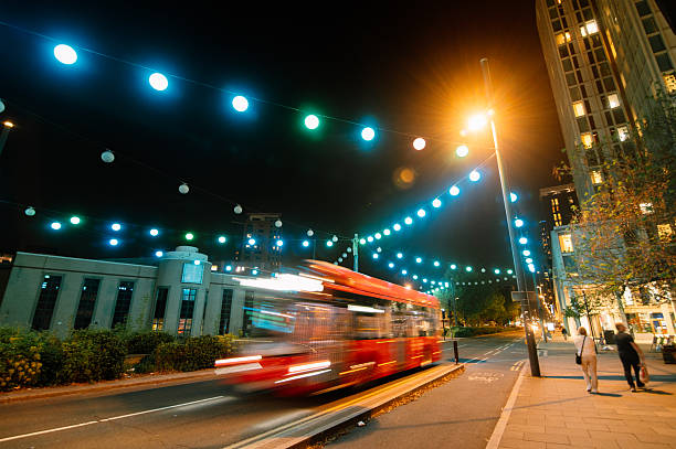 A London street at night with a bus in blurred motion