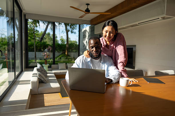 istock Multicultural couple working remotely, planning finances and investments online. Digital lifestyle 2215017606