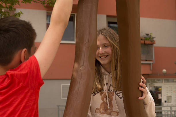 istock Children Engaging in Play at the Park with Interactive Fun Sculpture 2215018177