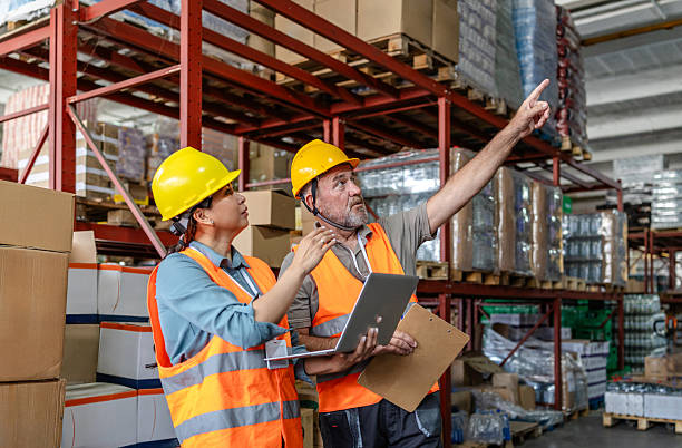 istock Warehouse workers collaborating on inventory management in a distribution center 2215018537