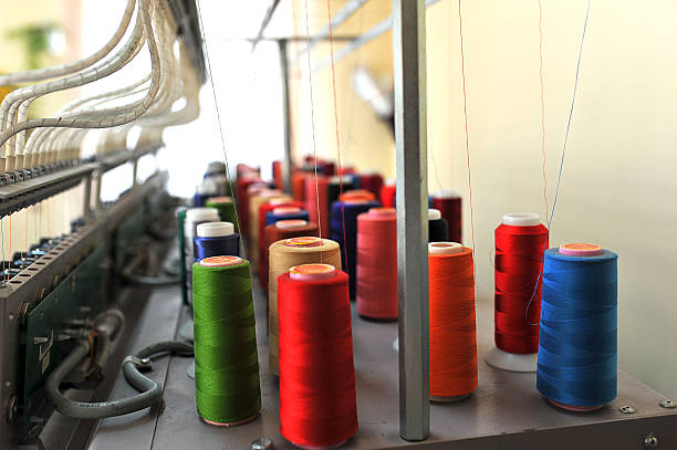 istock Colorful rows spools of thread stand on embroidery machine in garment industry 2215018773