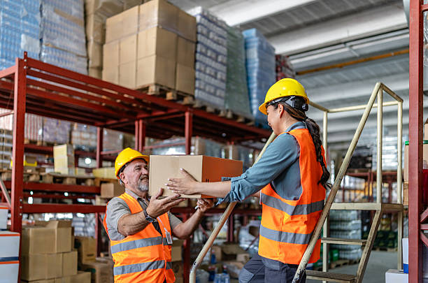 istock Warehouse workers collaborating on packaging and shipping tasks during a busy distribution day 2215019133