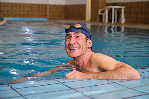istock Senior man relaxing in swimming pool after training 2215019315