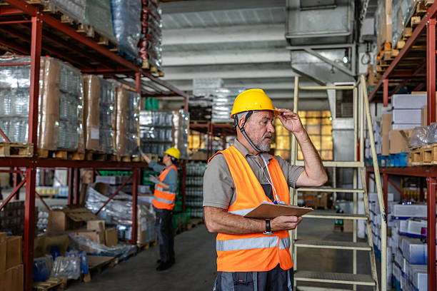 istock Warehouse workers conducting inventory checks in a distribution center while ensuring safety and efficiency 2215020051