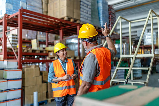istock Warehouse workers discussing safety protocols and workflow in a busy distribution center during working hours 2215020282