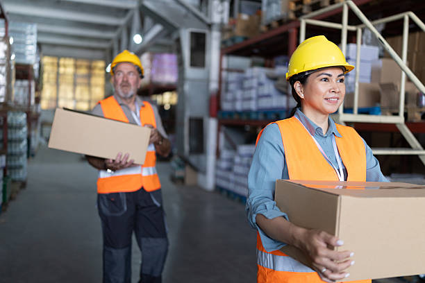 istock Warehouse workers efficiently handling packages in a busy distribution center during operational hours 2215020533