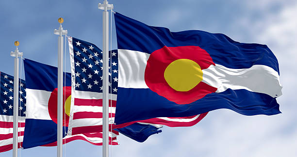 istock Colorado state and American flags waving in wind under blue sky. 3D render 2215021341