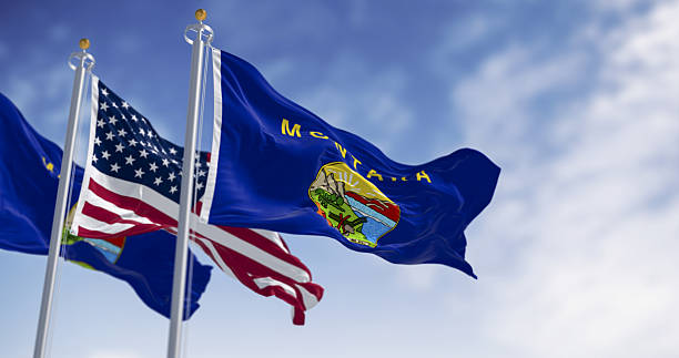 istock Montana state flag and US national flag waving together outdoors. 3D render. 2215021391