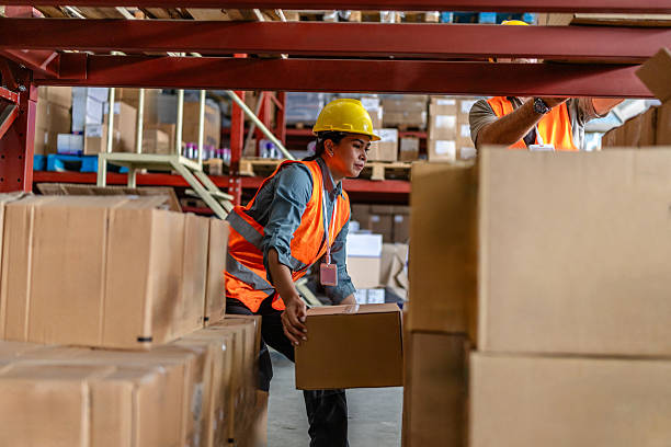 istock Warehouse workers handling boxes in a busy e-commerce distribution center during daylight hours 2215021922