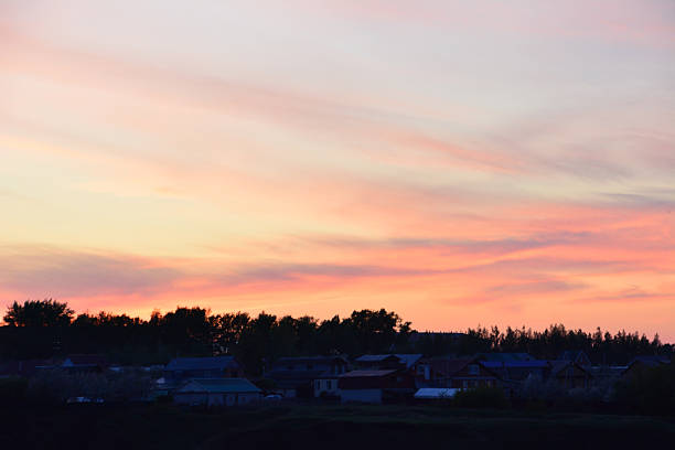 Sunset over a village with a colorful sky