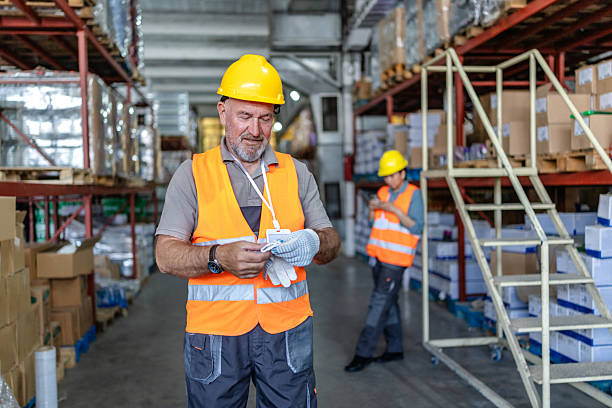 istock Warehouse workers preparing for tasks in a distribution center focused on safety and efficiency 2215023146
