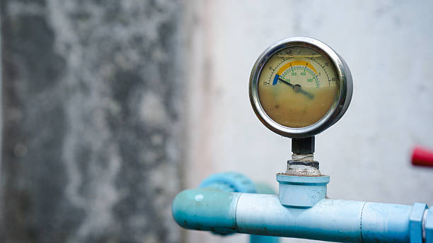 istock Pressure gauge on a blue pipe, displaying measurement against a blurred background. 2215024763