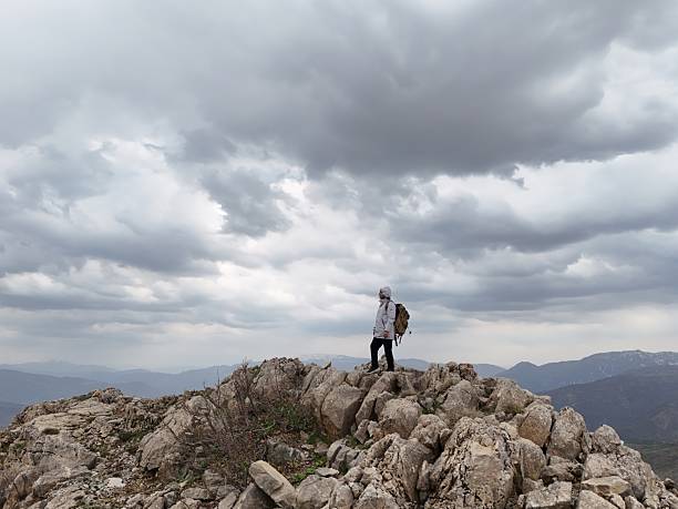The climber on top of a mountain with a backpack