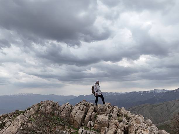 The climber on top of a mountain with a backpack