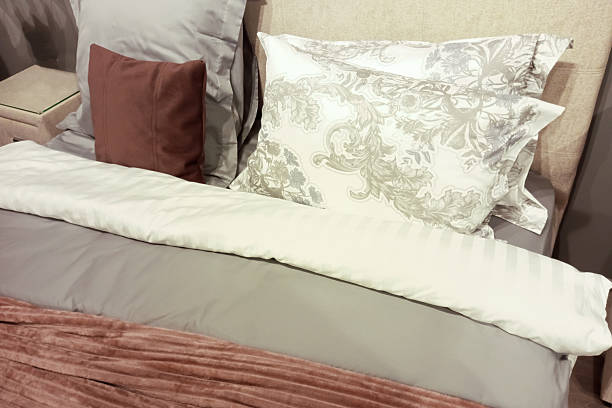 istock Headboard with pillows and bedspread in beige and brown colors. 2215027767