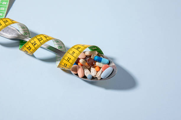 istock Spoon with Pills and Tape Measure 2215028366