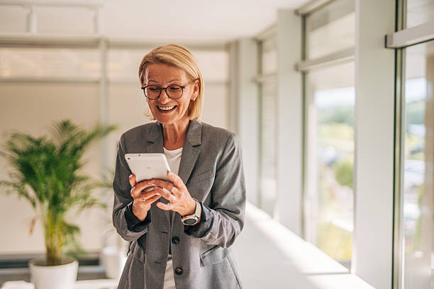 istock Smiling businesswoman using digital tablet in modern office 2215030552