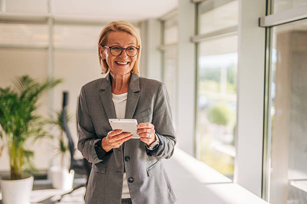istock Smiling senior businesswoman using digital tablet in modern office 2215030553